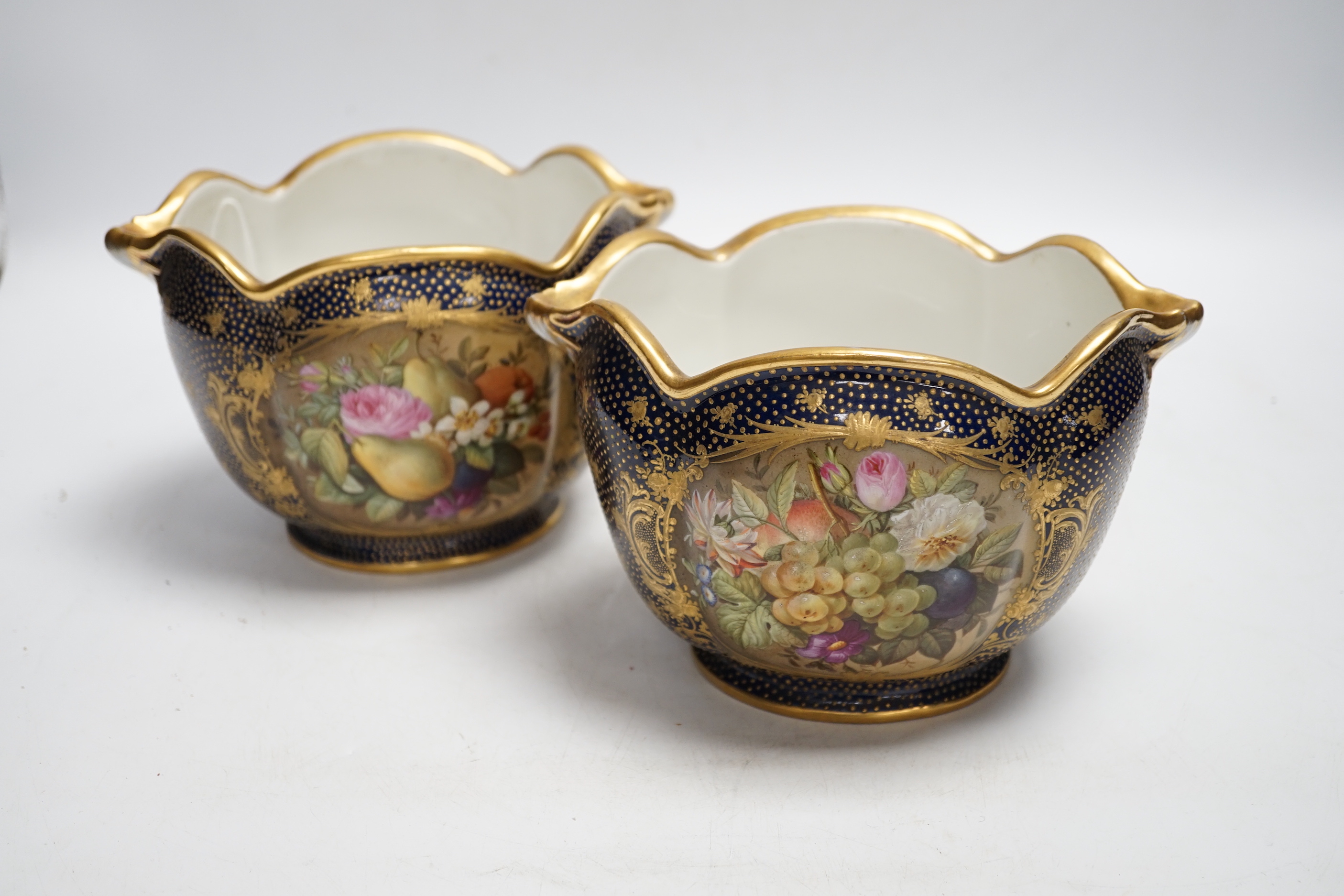 A pair of 19th century Paris porcelain cache pot hand painted with flowers and gilded decoration, 12cm high